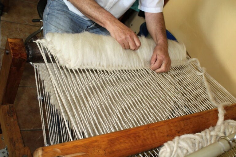 A close-up view of the hands in the weaving process.
